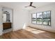 Bedroom with hardwood floors and large windows overlooking a green landscape at 1056 Snell Isle Ne Blvd, St Petersburg, FL 33704