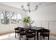 Bright dining room with a modern chandelier, large windows, and seating for six at 1056 Snell Isle Ne Blvd, St Petersburg, FL 33704