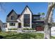 Beautifully designed two-story home with stone and dark siding accents and lush green lawn at 1056 Snell Isle Ne Blvd, St Petersburg, FL 33704