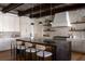 Stylish kitchen featuring stone backsplash, modern lighting, and island with barstool seating at 1056 Snell Isle Ne Blvd, St Petersburg, FL 33704