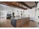 Open-concept kitchen with a large island, wood beam ceiling, fireplace and stainless appliances at 1056 Snell Isle Ne Blvd, St Petersburg, FL 33704