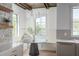 Kitchen nook featuring a stone accent wall, custom lighting, and built-in bench seating at 1056 Snell Isle Ne Blvd, St Petersburg, FL 33704