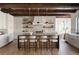 Gourmet kitchen with wood beam ceiling, stone wall, island, and stainless steel appliances at 1056 Snell Isle Ne Blvd, St Petersburg, FL 33704