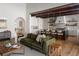 Open-concept living area with a large green sofa, hardwood floors, and seamless flow to a modern kitchen at 1056 Snell Isle Ne Blvd, St Petersburg, FL 33704