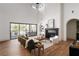 Bright living room featuring a fireplace, tall ceilings, a large window, and an open floor plan at 1056 Snell Isle Ne Blvd, St Petersburg, FL 33704