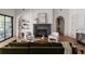 Inviting living room features a stone fireplace, comfortable seating, and arched doorways for added charm at 1056 Snell Isle Ne Blvd, St Petersburg, FL 33704