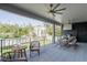 Covered outdoor patio with ceiling fans, dining area, grill and nice view at 1056 Snell Isle Ne Blvd, St Petersburg, FL 33704