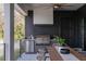 Well-equipped outdoor kitchen with built-in grill, refrigerator, and adjacent dining area at 1056 Snell Isle Ne Blvd, St Petersburg, FL 33704