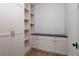 Bright storage room with custom built-in shelving and sleek countertops providing ample storage at 1056 Snell Isle Ne Blvd, St Petersburg, FL 33704