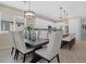 Open concept dining area with modern chandelier and view into the kitchen and island seating at 5819 Mezzana Run, Palmetto, FL 34221