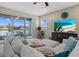 Living room featuring a comfortable sofa and a view of the water and nearby houses at 5819 Mezzana Run, Palmetto, FL 34221