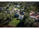 Aerial view of a home showcasing a pool, lush landscaping, and a well-maintained outdoor space at 7705 Weeping Willow Cir, Sarasota, FL 34241