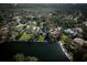 Aerial view of the home backing to the lake highlighting the lush surrounding landscape at 7705 Weeping Willow Cir, Sarasota, FL 34241