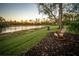 Scenic backyard featuring a tranquil pond and comfortable rocking chair at 7705 Weeping Willow Cir, Sarasota, FL 34241