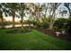 Lush landscaped backyard with pond access at 7705 Weeping Willow Cir, Sarasota, FL 34241
