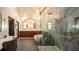 Luxurious bathroom featuring a glass-enclosed shower, soaking tub, vanity, and modern fixtures at 7705 Weeping Willow Cir, Sarasota, FL 34241