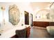 Luxurious bathroom with modern mirrors, gorgeous vanity and sink, plus a stand alone tub at 7705 Weeping Willow Cir, Sarasota, FL 34241