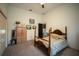 Relaxing bedroom featuring a wooden bed, closet, dresser, and artwork at 7705 Weeping Willow Cir, Sarasota, FL 34241