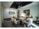 Charming dining room showcasing a wooden table, soft white chairs, unique chandelier and a decorative mirror that adds character at 7705 Weeping Willow Cir, Sarasota, FL 34241