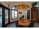 Bright dining room featuring a unique wood table, stylish seating, and modern lighting fixture at 7705 Weeping Willow Cir, Sarasota, FL 34241