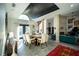 Stunning dining area with a modern chandelier, tall ceilings, and access to the outdoor space, perfect for entertaining at 7705 Weeping Willow Cir, Sarasota, FL 34241