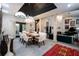 Stunning dining room featuring a modern chandelier, tall ceilings, and access to the outdoor space, perfect for entertaining at 7705 Weeping Willow Cir, Sarasota, FL 34241