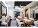 Elegant dining room showcasing a modern chandelier, tall ceilings, and access to the outdoor space, creating a unique dining experience at 7705 Weeping Willow Cir, Sarasota, FL 34241
