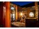 Inviting entrance with an artistic fountain, stylish lighting, and brick facade at dusk at 7705 Weeping Willow Cir, Sarasota, FL 34241