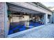 Large garage space featuring blue and black tiled flooring at 7705 Weeping Willow Cir, Sarasota, FL 34241
