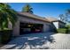 Spacious three-car garage with storage and vehicles at 7705 Weeping Willow Cir, Sarasota, FL 34241