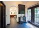 Hallway featuring access to a luxurious bathroom, natural light from doors and unique furnishings at 7705 Weeping Willow Cir, Sarasota, FL 34241