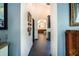 Inviting hallway with archways leading to a modern bathroom featuring tile flooring and stylish decor at 7705 Weeping Willow Cir, Sarasota, FL 34241