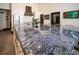 Stunning kitchen island boasting exquisite blue granite countertops, gold fixtures, and ample seating space that enhances its appeal at 7705 Weeping Willow Cir, Sarasota, FL 34241