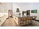 Modern kitchen featuring a large island with granite countertops, white cabinets, and sleek appliances, blending style and functionality at 7705 Weeping Willow Cir, Sarasota, FL 34241