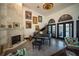 Spacious living room featuring high ceilings, stone fireplace, and a grand piano at 7705 Weeping Willow Cir, Sarasota, FL 34241