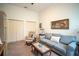 Comfortable living room with soft-colored sofa, armchair, and bright natural light at 7705 Weeping Willow Cir, Sarasota, FL 34241