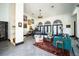 Spacious living room with abundant natural light, featuring a grand piano, cozy seating area, and artistic decor at 7705 Weeping Willow Cir, Sarasota, FL 34241