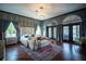 Comfortable main bedroom featuring stylish furniture, modern decor, natural light and colorful rug at 7705 Weeping Willow Cir, Sarasota, FL 34241