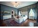 Comfortable main bedroom featuring stylish furniture, modern decor, natural light and colorful rug at 7705 Weeping Willow Cir, Sarasota, FL 34241