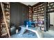 Spacious office space featuring floor to ceiling bookshelves, unique desk, and stylish decor at 7705 Weeping Willow Cir, Sarasota, FL 34241