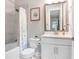 Full bathroom with tub and shower combo, and a large mirror over a white vanity at 31534 Westbury Estates Ave, Wesley Chapel, FL 33545