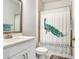 Bathroom featuring a white vanity and a shower with a decorative peacock-themed curtain at 31534 Westbury Estates Ave, Wesley Chapel, FL 33545