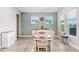 Dining room with green accent wall features wainscoting, windows and a decorative plate at 31534 Westbury Estates Ave, Wesley Chapel, FL 33545