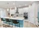 Modern kitchen features an island with seating, pendant lights, and stainless steel appliances at 31534 Westbury Estates Ave, Wesley Chapel, FL 33545