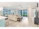 Open-concept living area boasts a large sectional, ceiling fan, and sliding doors to the lanai at 31534 Westbury Estates Ave, Wesley Chapel, FL 33545