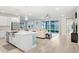 Open-concept space with a large kitchen island and sliding glass doors to the backyard at 31534 Westbury Estates Ave, Wesley Chapel, FL 33545