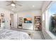 Bright main bedroom with a ceiling fan, built-in shelving, and large windows at 31534 Westbury Estates Ave, Wesley Chapel, FL 33545