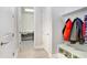 Mud room entrance with custom shelves, cubbies, and direct access to a laundry room at 31534 Westbury Estates Ave, Wesley Chapel, FL 33545