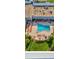 Aerial view of the pool and lounge area with seating and manicured grounds at 12209 Putter Green Ct, New Port Richey, FL 34654