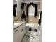 Chic bathroom showcasing a granite vanity, accessible tub, and marble-patterned flooring for a luxurious feel at 12209 Putter Green Ct, New Port Richey, FL 34654